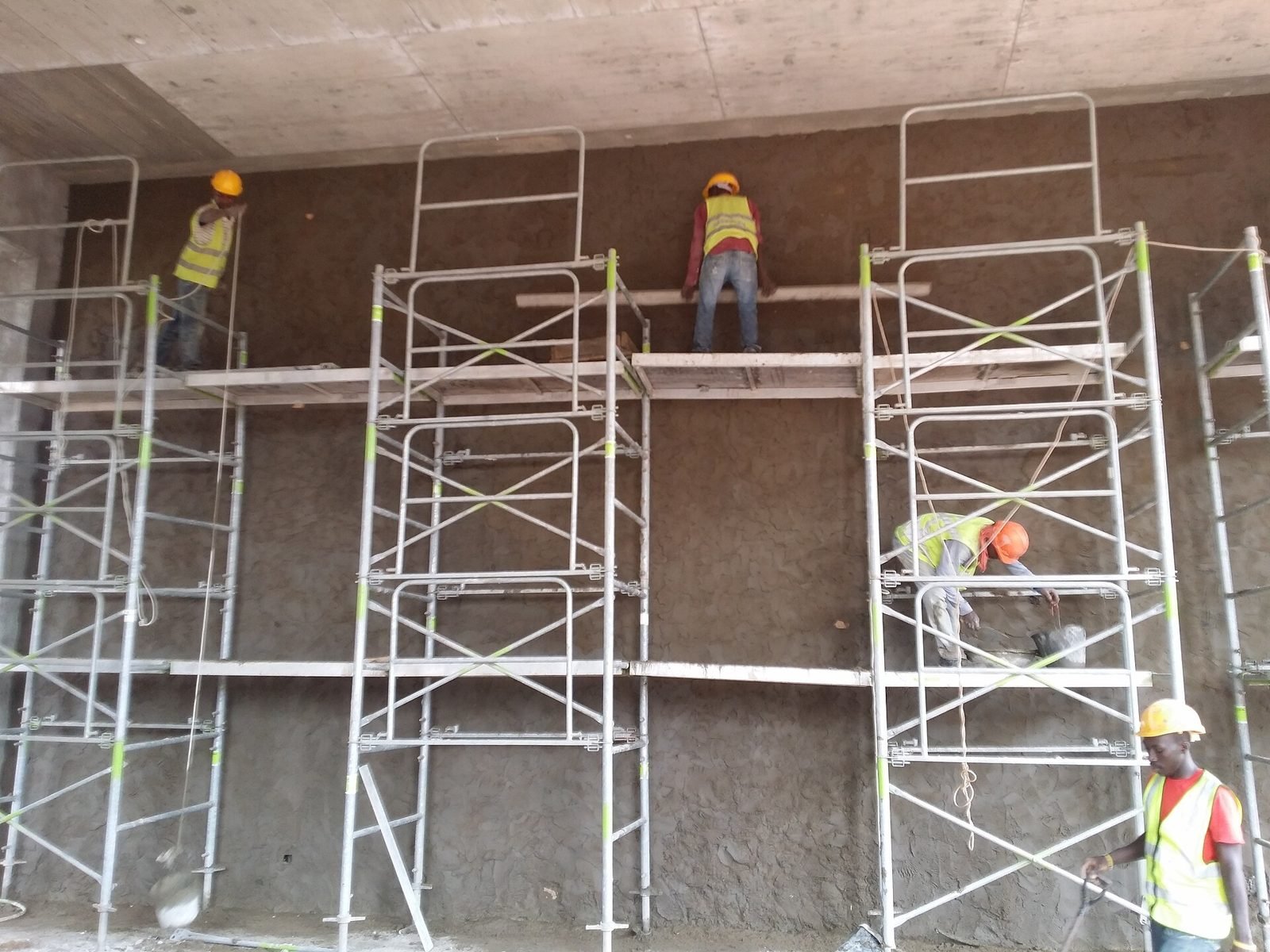 Plasterers on scaffolding in Accra
